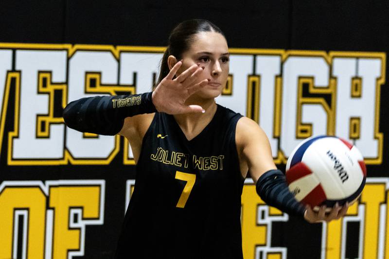 Joliet West's Lola Berta serves during a 4A sectional varsity volleyball game against Oswego at Joliet West on Nov. 4, 2025.