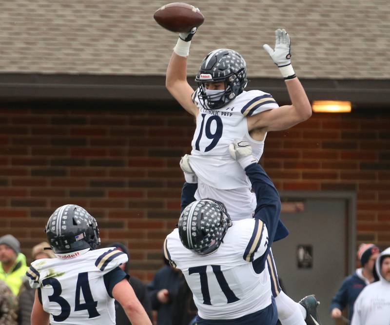 IC Catholic's Eric Karner (19) celebrates with teammates Isiah Gonzalez (71) and Giovanni Ortiz after scoring a touchdown against Princeton in the Class 3A Quarterfinal game on Saturday, Nov. 12, 2022 in Princeton.