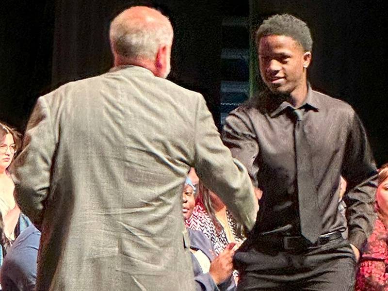 DeKalb High School graduate Jayden Wilson receiving the Michael Heimerdinger Scholarship