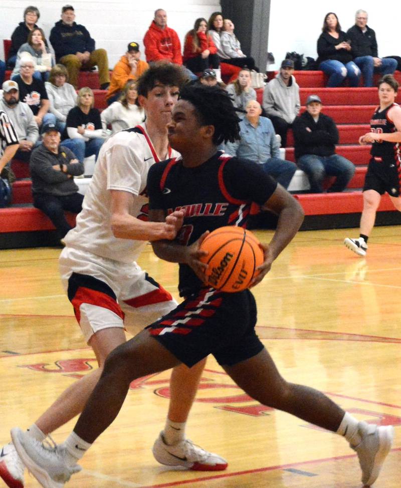 LaMoille's Cody Winn drives against Amboy in Saturday's third-place game of the LaMoille Holiday Classic. The Clippers won 55-45.