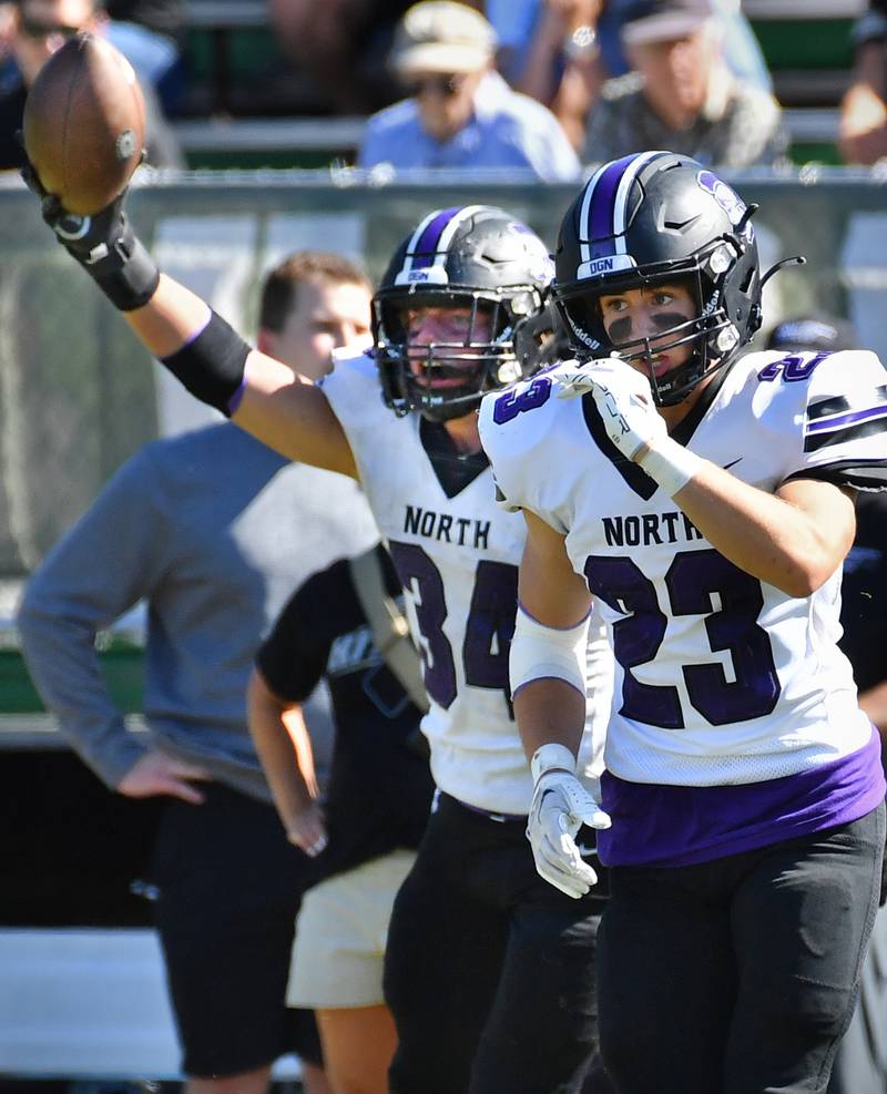 Downers Grove North's Jake Gregorio (34) holds the ball aloft escorted by teammate Ethan Kist (23) as they leave the field after Gregorio recovered a Glenbard West fumble during a game on Sep. 9, 2023 at Glenbard West High School in Glen Ellyn.
Jon Cunningham for Shaw Local News Network