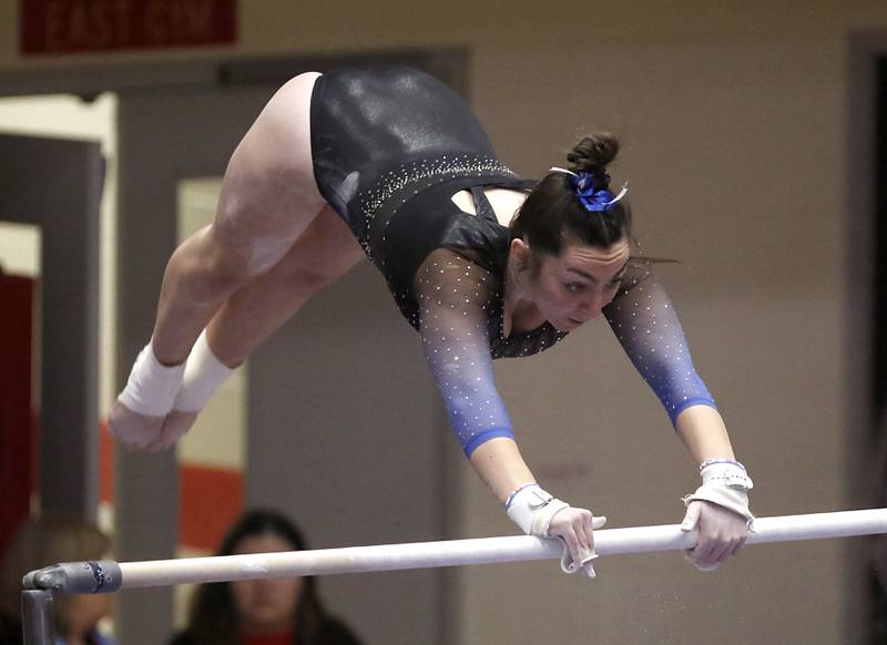 Geneva's Sadie Karlson competes in the preliminary round of the parallel bars Friday, Feb. 17, 2023, during the IHSA Girls State Final Gymnastics Meet at Palatine High School.