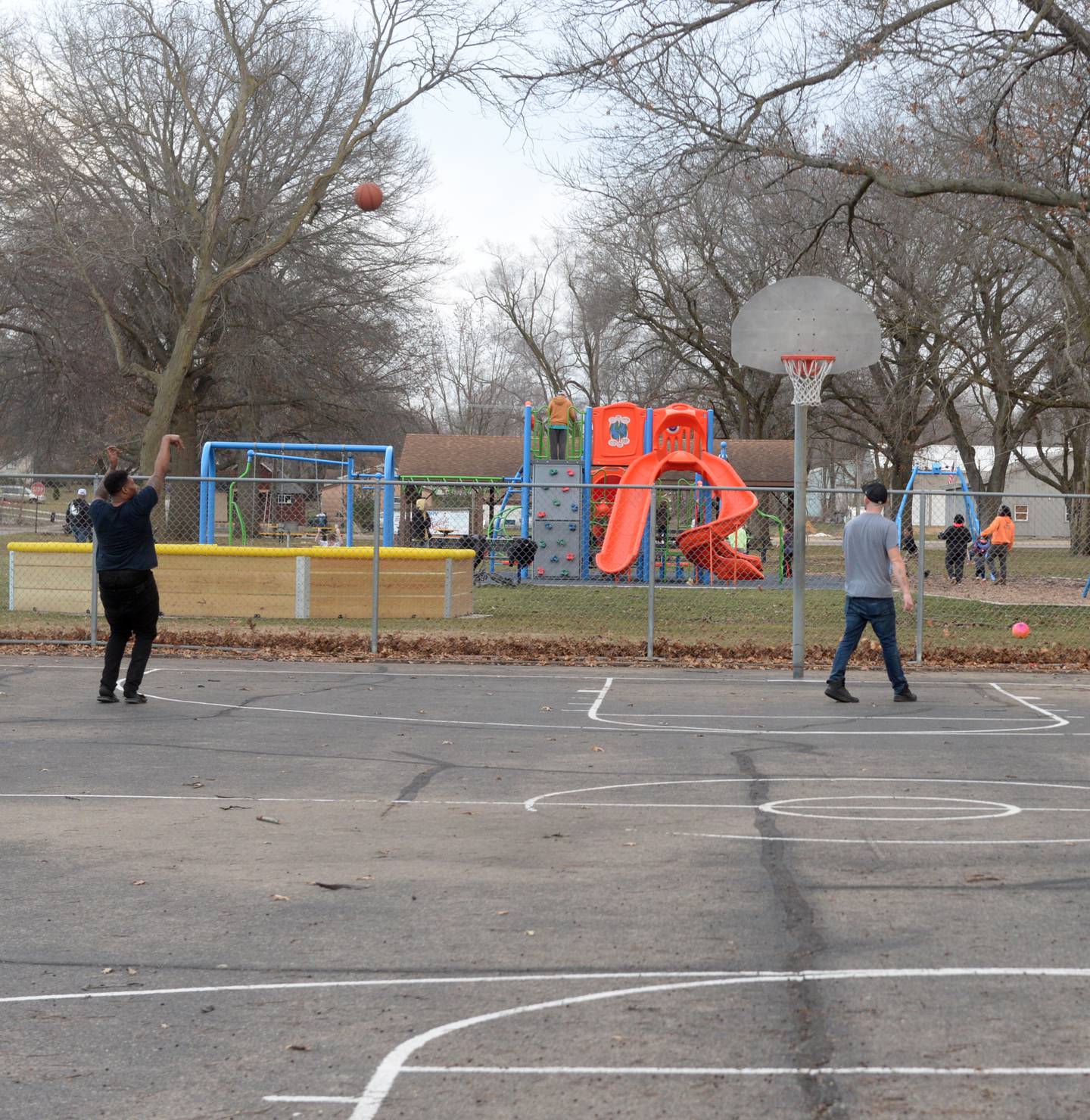 Two men shoot some hoops at the basketball court at Vaile Park in Dixon on Thursday, Feb. 8, 2024. The Dixon Park District has received a state grant to improve the court.