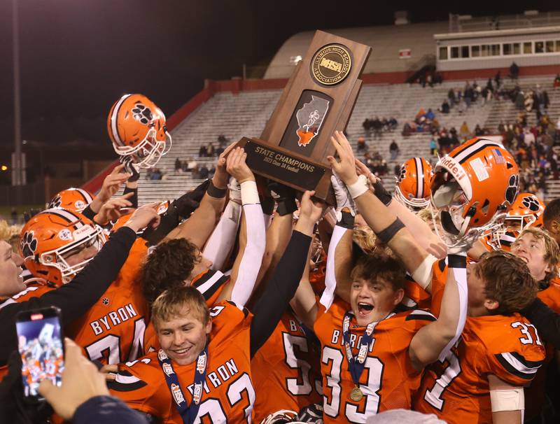 Members of the Byron football team hoist the Class 3A state championship trophy after defeating Mt. Carmel in the Class 3A State football championship on Friday, Nov, 24, 2023 at Hancock Stadium in Normal.