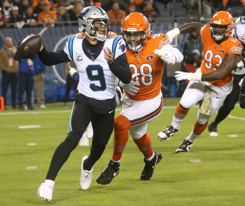 Carolina Panthers quarterback Bryce Young throws a pass as Chicago Bears defensive lineman Montez Sweat chases him down on Thursday, Nov. 9, 2023 at Soldier Field.