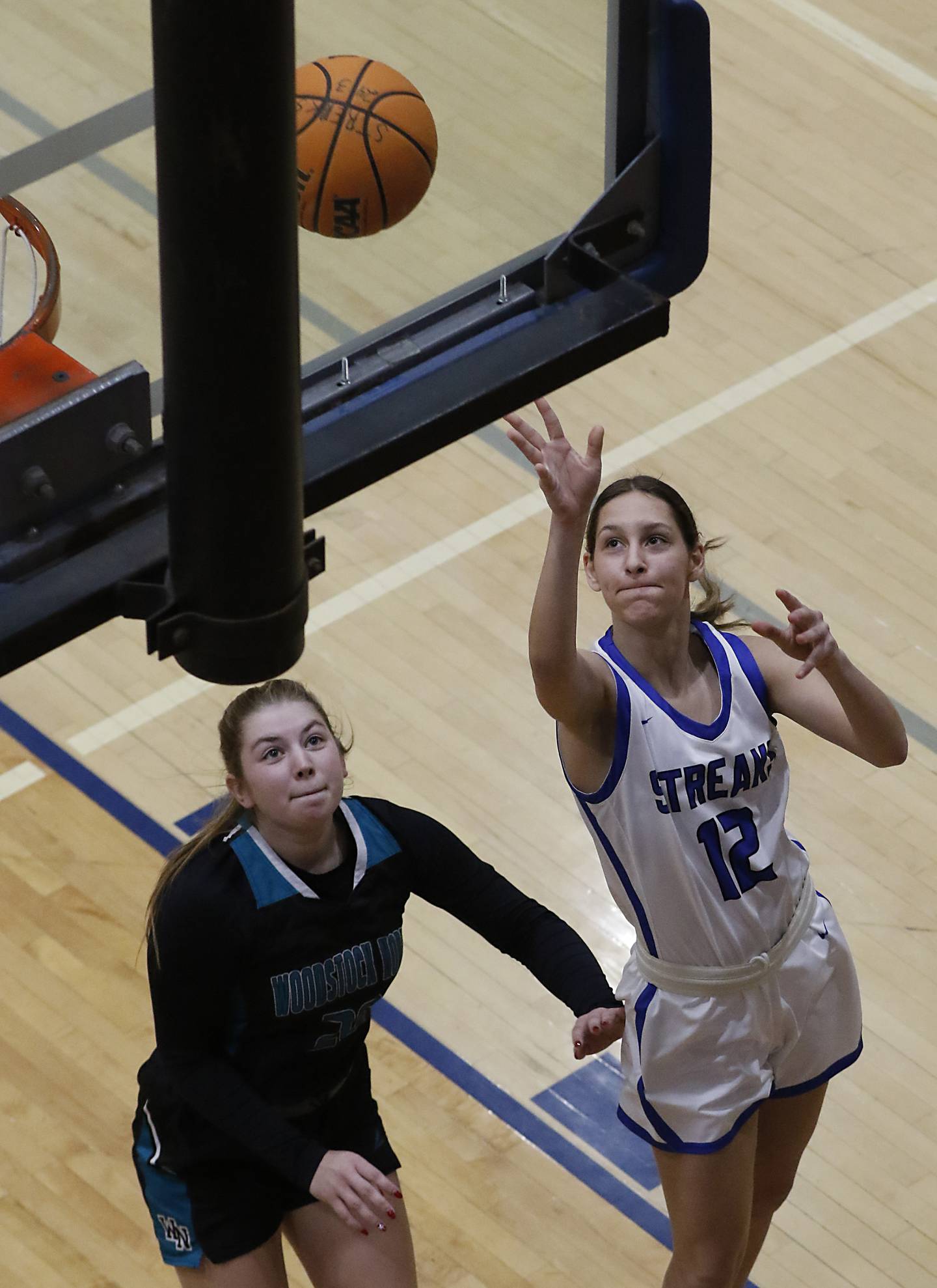 Woodstock's Victoria Cygan drives to tbaske against Woodstock North's Addison Udelhofen during a Kishwaukee River Conference basketball game on Friday, Jan. 10, 2025, at Woodstock High School.