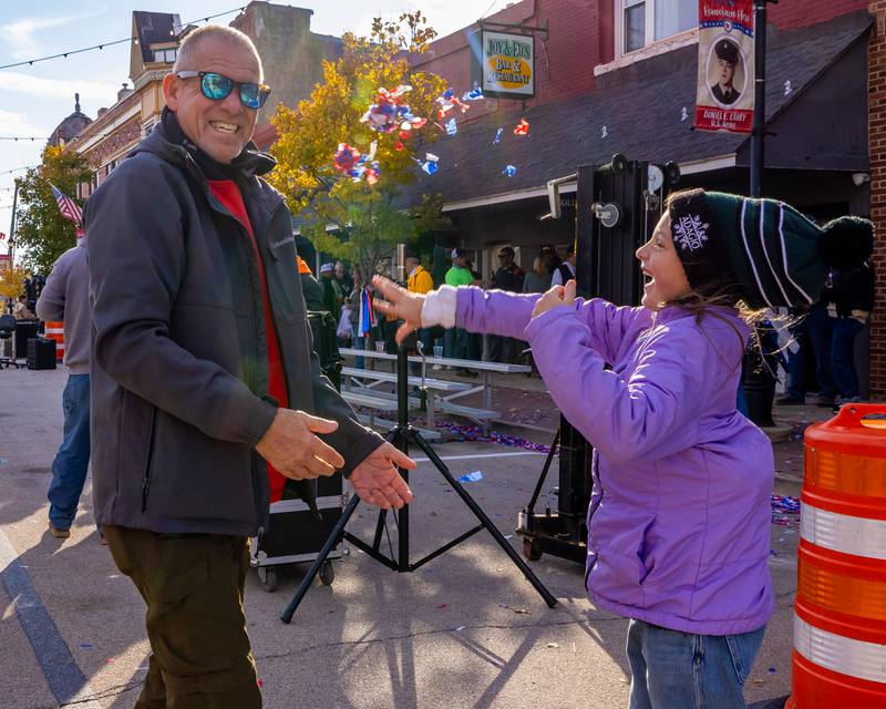 Bill Essman turns to avoid the patriotic confetti thrown by his grand daughter Blake Essman after the Utica Veterans Parade and Airshow on November 2, 2025 in Utica.
