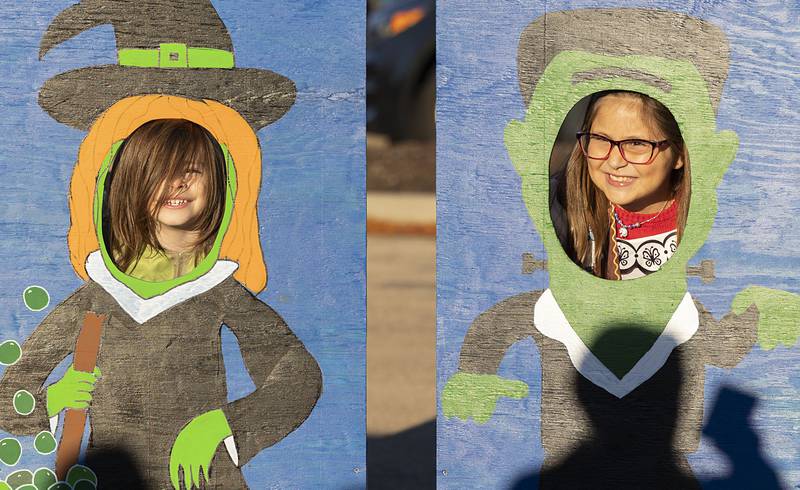 Grayson Wyatt (left), 5, and Cinda Garcia, 9, pose for pictures Wednesday, Oct. 26, 2022 while attending Sterling Police Department’s trunk or treat event. Hundreds of kids with their families in tow attended the event.