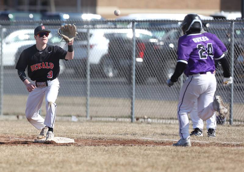 DeKalb’s Nikolas Nelson takes a throw as Dixon’s Kyan Adkins hustles down the line after a sacrifice bunt during their game Tuesday, March 28, 2023, at DeKalb High School.