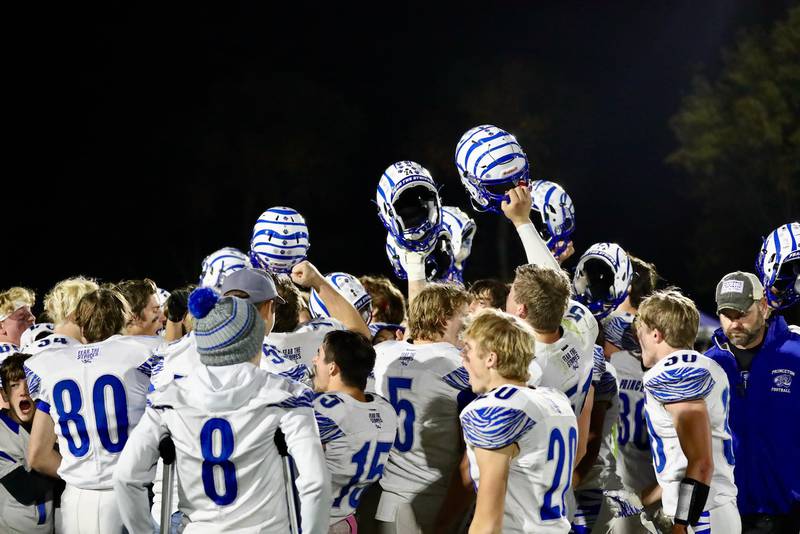 The Princeton Tigers raise their helmets after Friday's 48-0 win at Monmouth-Roseville to finish the season 9-0. PHS will host Peotone in the 3A Playoffs at 6 p.m. Friday.