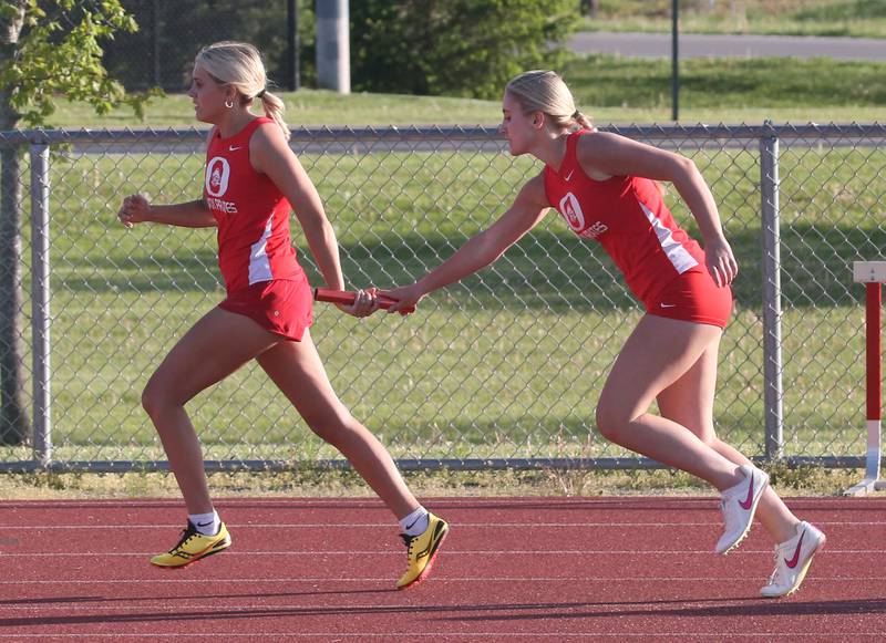 Ottawa's Ava Weatherford and Ashlynn Gainere run in the 4x200 relay during the Interstate 8 conference track meet on Friday, May 3, 2024 at the L-P Athletic Complex in La Salle.