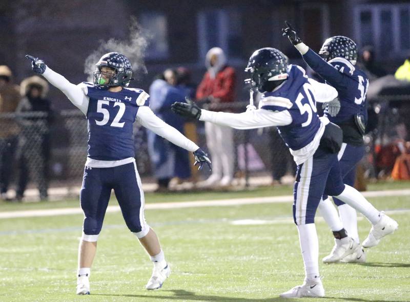 IC Catholic's Jesse Smith (52) and teammates signal a first down after a fourth down stop during the Class 3A varsity football semi-final playoff game between Byron High School and IC Catholic Prep on Saturday, Nov. 19, 2022 in Elmhurst, IL.