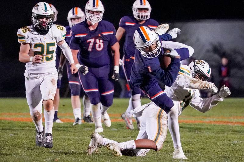 Oswego’s Jeremiah Cain (1) dives forward after catching a pass against Waubonsie Valley's Josh Hung (18) during a Class 8A first-round playoff game at Oswego High School on Friday, Nov. 1, 2024.