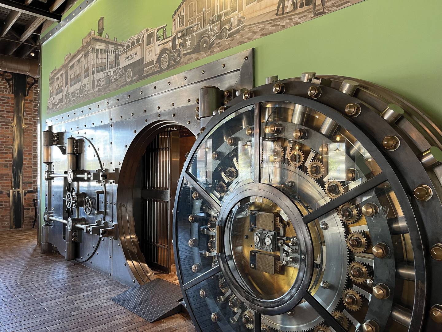 Bank vault doors are a focal point in the dining room of Gaetano's Vault, a restaurant inside a renovated bank building. The restaurant leans into a 1920s gangster theme.