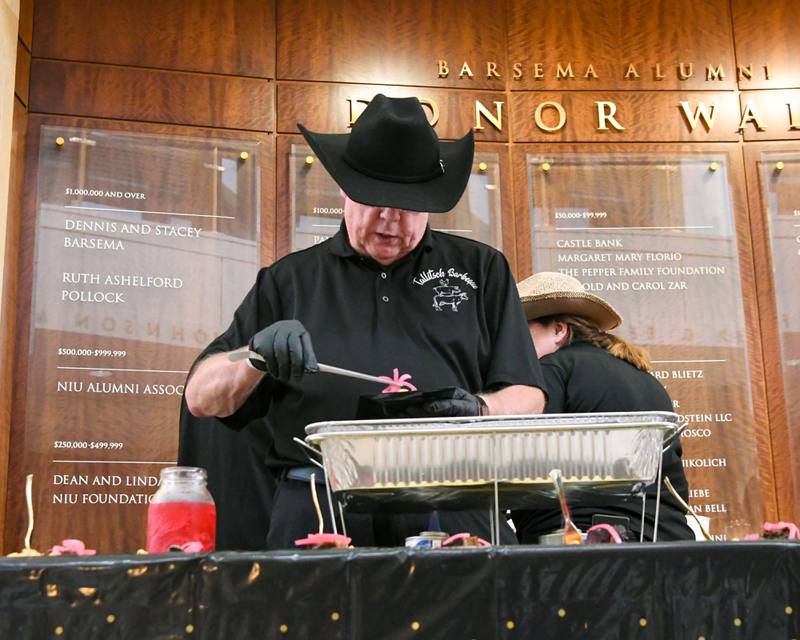 Steve Tallitsch of Talitsch BBQ & Catering dishes out samples before the start of the 21st 50 Men Who Cook fundraiser, an event hosted by CASA DeKalb County on Saturday, Aug. 9, 2025, held at Northern Illinois University's Barsema Alumni and Visitors Center.