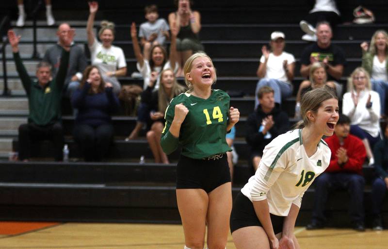 Crystal Lake South’s Maddy Cook, left, and Grace Meyer celebrate a Gator win in varsity volleyball at McHenry Tuesday night.