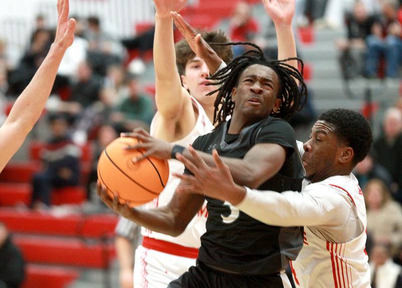 Kaneland's Marshawn Cocroft gets through for a shot during a game against Naperville Central on Tuesday, Jan. 14, 2025 in Naperville.