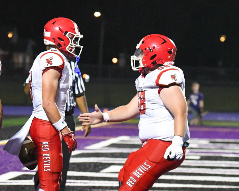 Hinsdale Central's Jack Lesniewicz, left, gets congratulated by teammate Grant Cook, after Jack scored a touchdown during the game on Friday Sept. 12, 2025, while traveling to take on Downers Grove North.