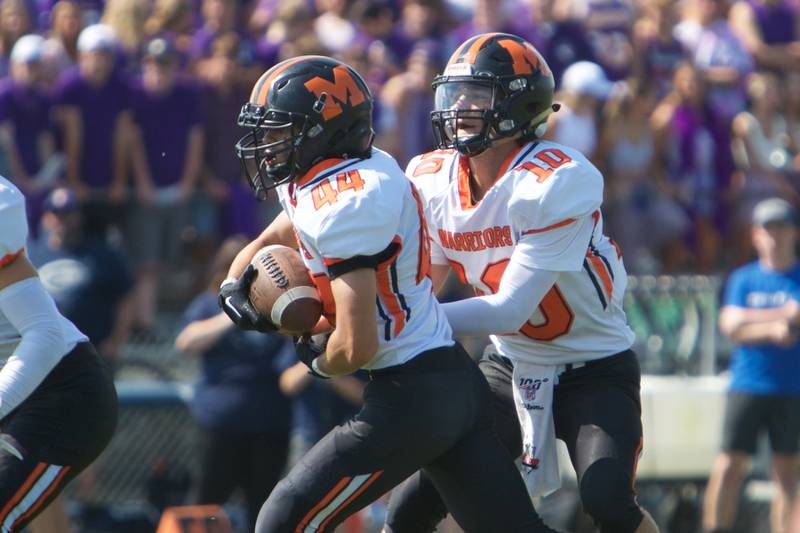 McHenry's Dominick Caruso hands the ball off to Jacob Jones against Cary - Grove on Saturday, Sept. 17,2022 in Cary.