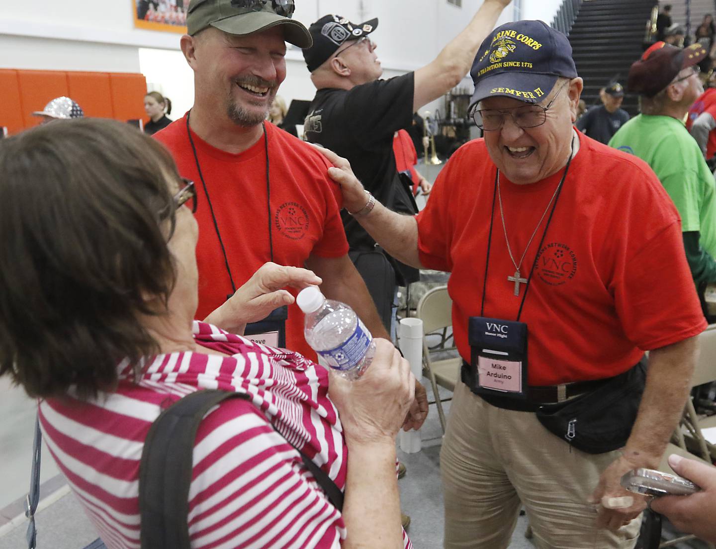 U.S. Army National Guard veteran Dave Bloomfield, U. S. Army veteran Mike Arduino, laugh with Arduino’s wife Barbara, after returning from an Honor Flight trip to Washington D.C., during a celebration on Sunday, Aug. 27, 2023, at McHenry Community High School’s Upper Campus.