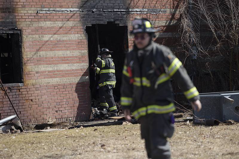 Dixon City firefighters work to extinguish hot spots in the afternoon on Monday, March 2, 2026, after previously fighting a fire in the 1100 block of West First Street.