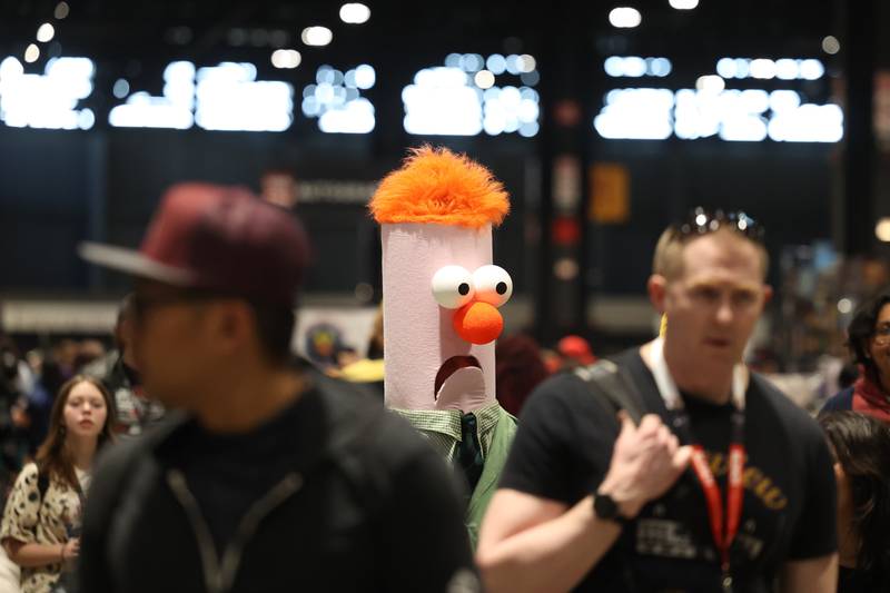 A person dressed as Beaker, from the Muppets, walks around the show floor at C2E2 Chicago Comic & Entertainment Expo on Sunday, April 2, 2023 at McCormick Place in Chicago.