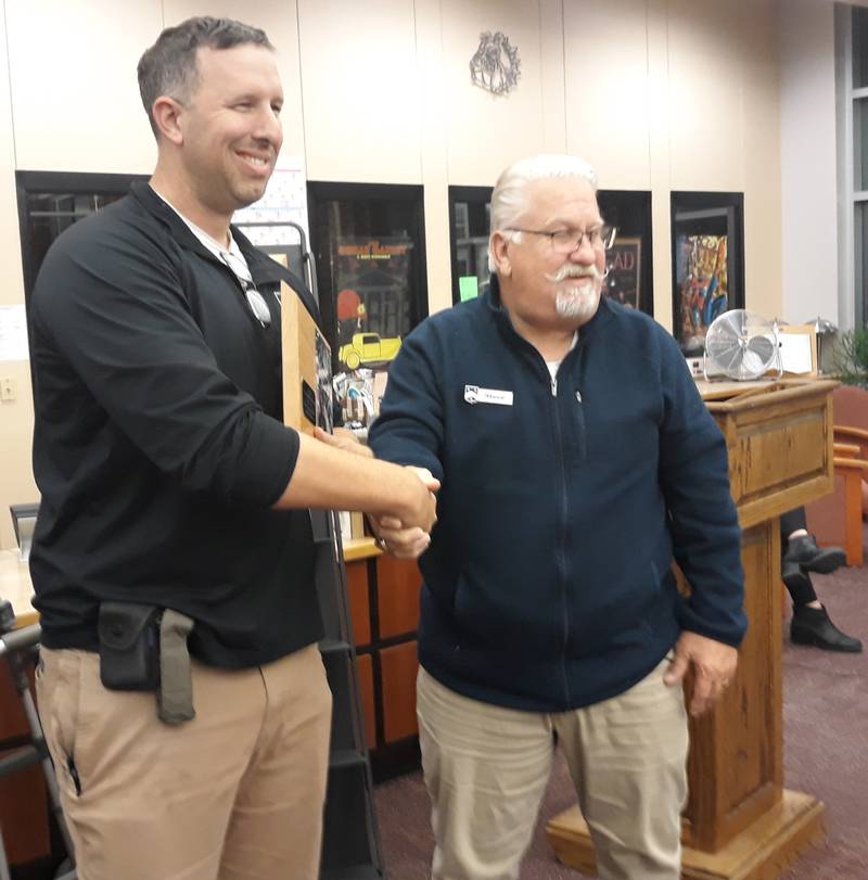 Military veteran JT Huey shakes hands with Streator High School Board President Steve Biroschik after he receives a plaque for his service Tuesday, Nov. 15, 2022, during the school district's board meeting.
