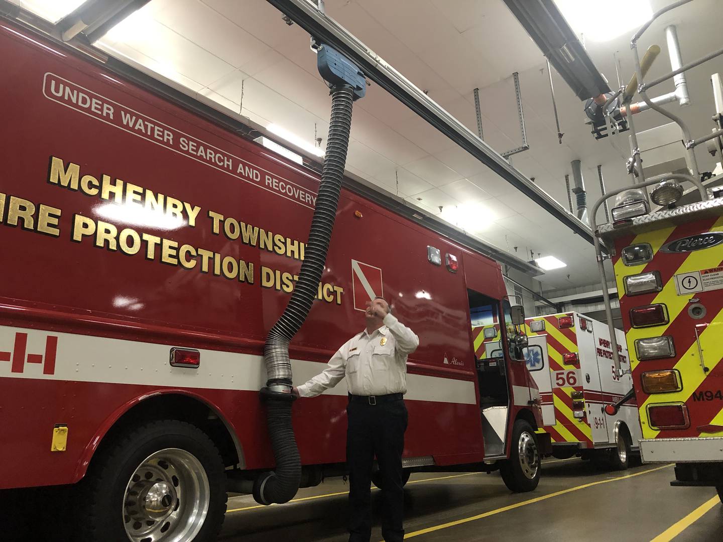 Chief Rudy Horist shows how piping attached to a fire truck's exhaust system helps keep diesel fumes, a known carcinogen, from filtering into the air at McHenry Township Fire Protection District's Station 1 on Jan. 23, 2023.