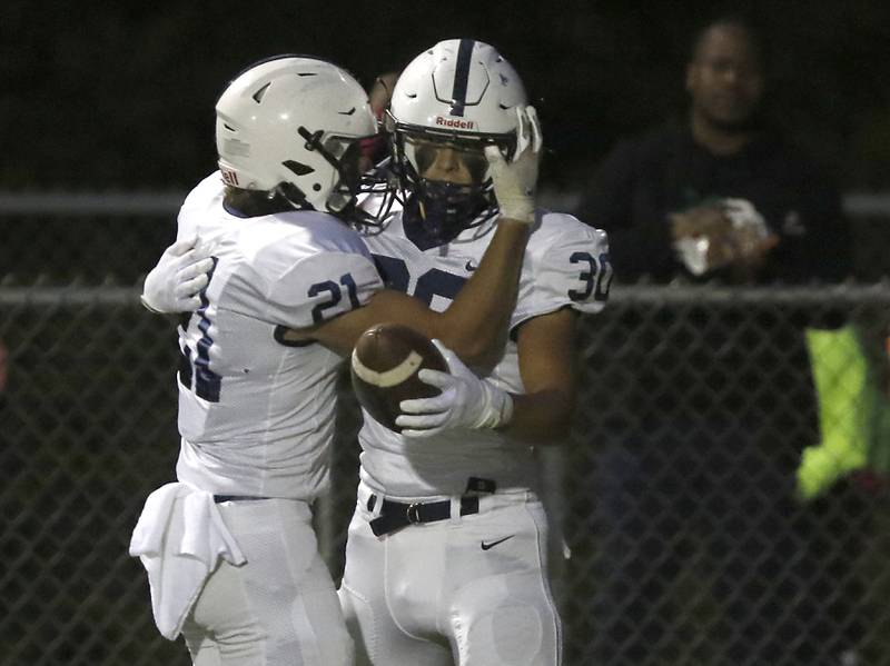 Cary-Grove's Ales Schuppe, right, celebrates a touchdown with his teammate, Mayal Kanellakis, during a Fox Valley Conference football game between Prairie Ridge  and Cary-Grove Friday, Sept. 23, 2022, at Prairie Ridge High School in Crystal Lake.