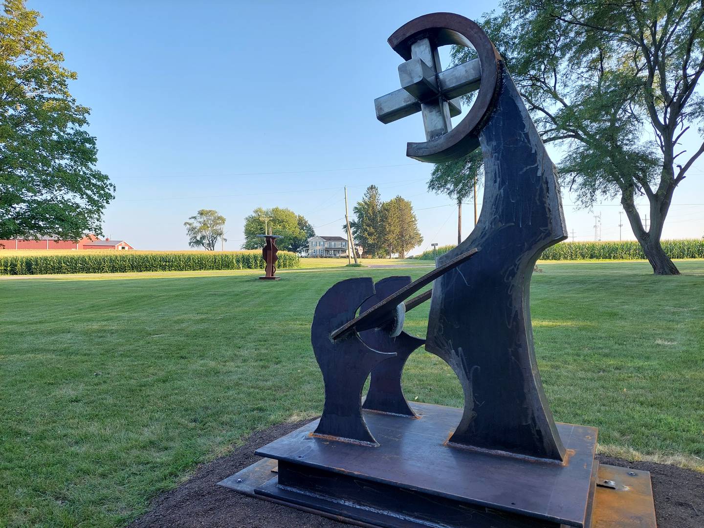 Don Noon's newest sculpture (front) is seen in front of a previous sculpture, both on display at Marilla Park in Streator.