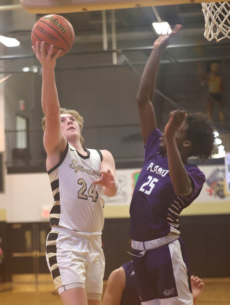 Sycamore's Lucas Winburn gets up a shot over Plano's Christ Keleba Tuesday, Jan. 3, 2023, during their game at Sycamore High School.
