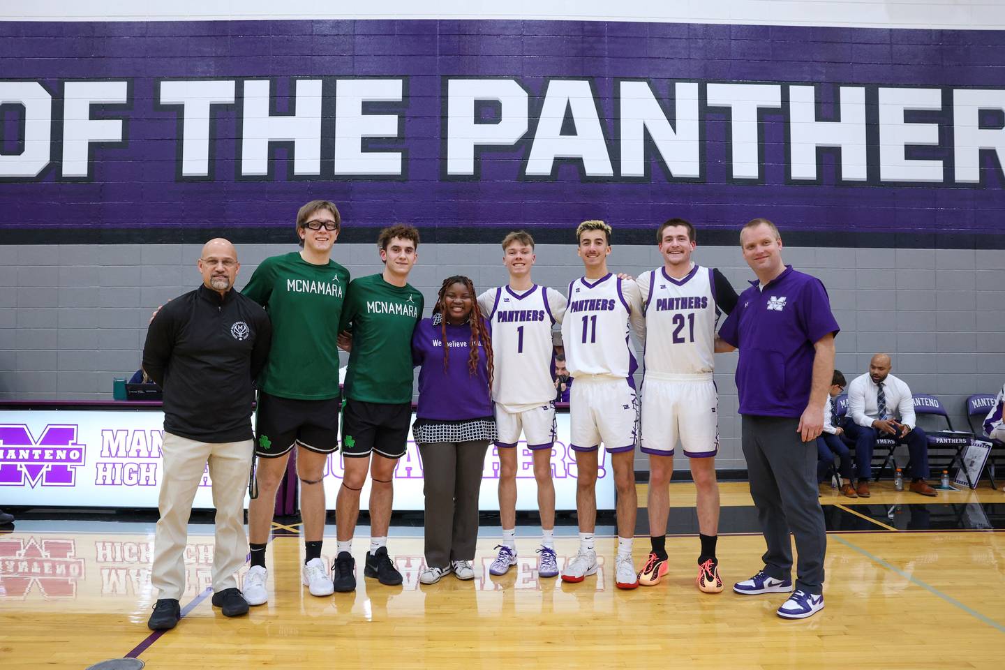 Harbor House prevention advocate Stephanie, center, stands with Manteno and Bishop McNamara players as the schools hosted Safe Harbor Night, collecting donations during their game to benefit Harbor House on Tuesday, Jan. 13, 2026.