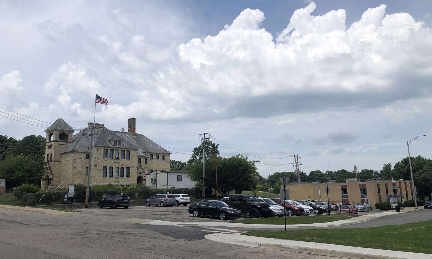 If development is approved by the city, the former city hall lot, right, would hold a six-level apartment building with two levels of parking and four of housing units. Landmark Elementary School is on the left, seen here on Thursday, June 13, 2024.