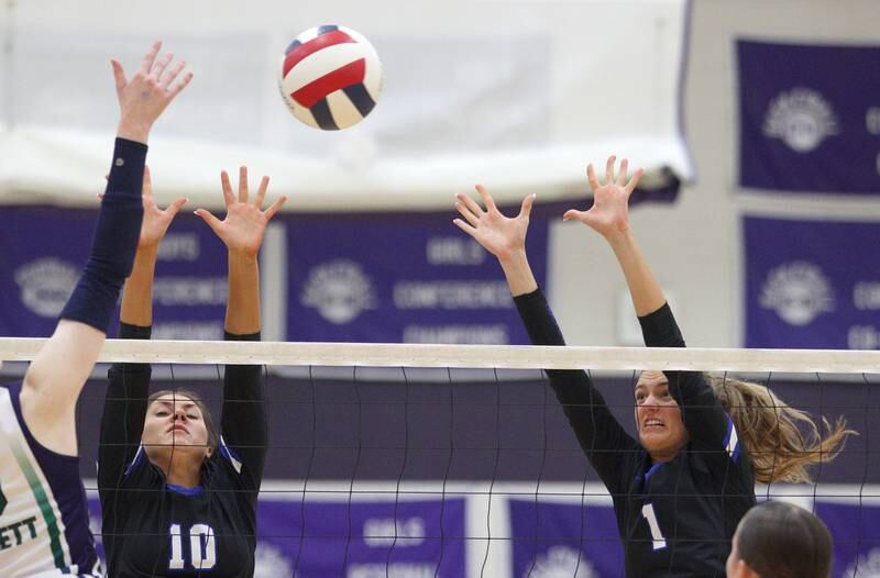 Burlington Central’s Julia Johnson, left, and Peyton Strout block against Bartlett in varsity volleyball tournament action on Saturday, Sept. 21, 2024, at Hampshire High School in Hampshire.