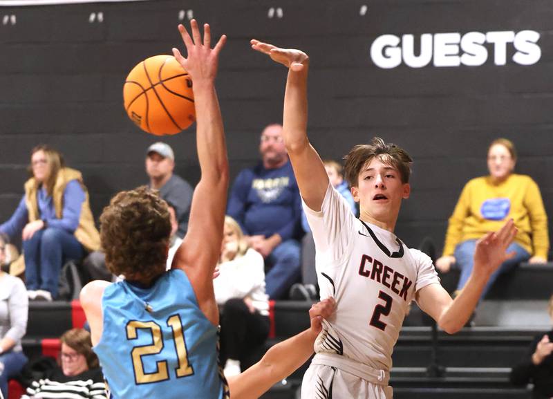 Indian Creek's Jason Brewer makes a pass over Marquette’s Lucas Craig Monday, Dec. 9, 2025, during their game at Indian Creek High School in Shabbona.