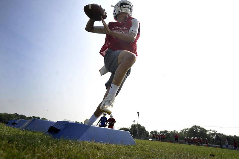 Dundee-Crown quarterback Evan Echlin prepares to throw the football as he runs a drill on July 8 at Dundee-Crown in Carpentersville.