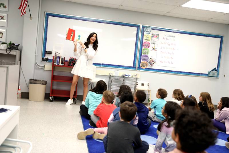 Ashley Honn, a teacher librarian/interventionist  at Henry Puffer Elementary School in Downers Grove, reads a story to second graders. Honn was honored with a a Green Apple Award through the Education Foundation of Downers Grove District 58.