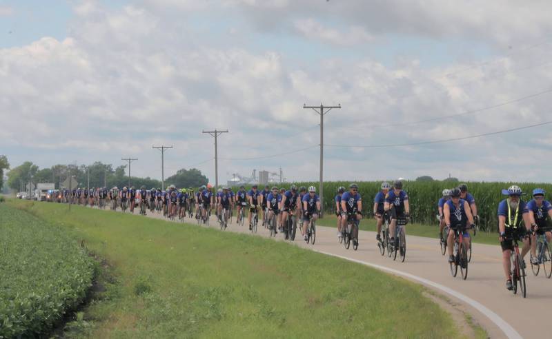 Cyclists participating in Cycle Across Illinois, a charity campaign to honor fallen police officers and raise funds for their families, bike along Illinois Route 23 on their way to DeKalb on Saturday, July 12, 2025.