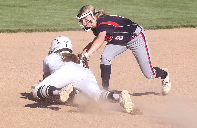 Kaneland's Kailey Plank is tagged by Belvidere North's McKenzie Culvey as she slides back into second Friday, June 3, 2022, during their IHSA Class 3A Sectional final game at Sycamore High School.