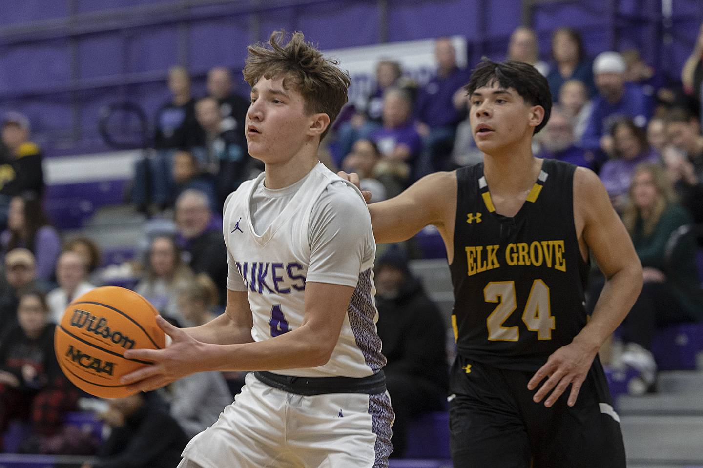 Dixon’s Brody Nicklaus dishes off a pass while being guarded by Elk Grove’s Matt Novak Saturday, Jan. 11, 2025, at Dixon High School.