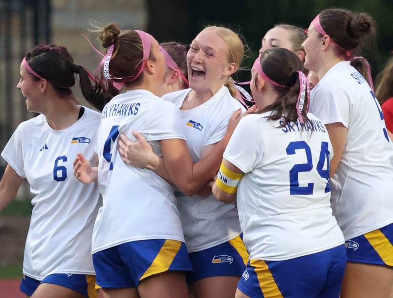Johnsburg's Kayla Hiller (middle) is mobbed by her teammates after scoring a goal Thursday, June 5, 2025, during their IHSA Class 1A state semifinal game against Timothy Christian at North Central College in Naperville.