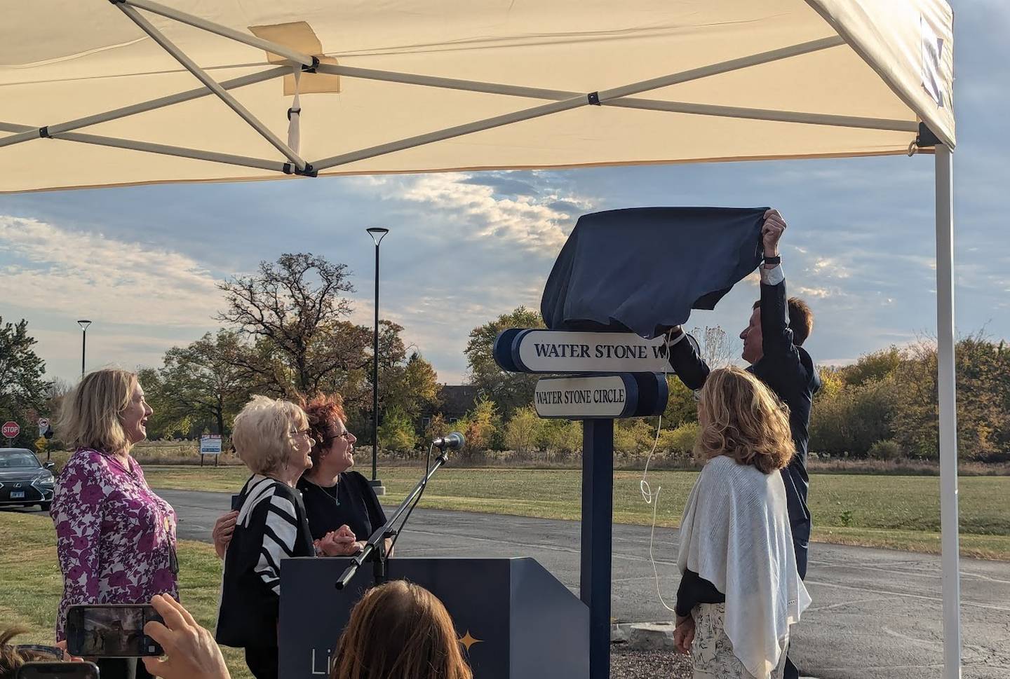 Lightways Hospice and Serious Illness Care in Joliet unveiled its new sign for Honorary Duane Krieger Drive in honor of its former CEO Duane Krieger of Shorewood on his 88th birthday, Tuesday, October 22, 2024. Pictured from left are Danette Krieger (Duane Krieger's daughter), Dee Krieger (Duane Kriger's wife), Lightways CEO Mary Kay Sheehan, Diane Welch (Duane Krieger's daughter) and Douglas Krieger (Duane Krieger's son).