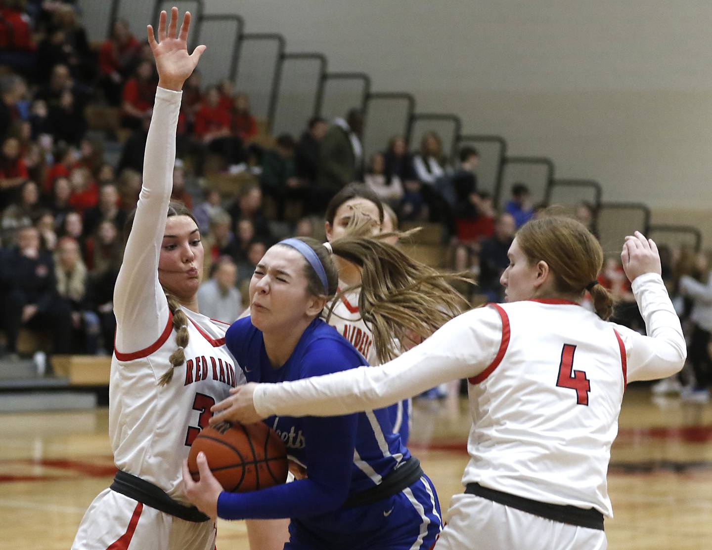 Burlington Central's Emma Payton tries to drive to the basket between Huntley's Ava McFadden (left)  and Isabella Boskey during a Fox Valley Conference girls basketball game Friday, Feb.2, 2024, at Huntley High School.