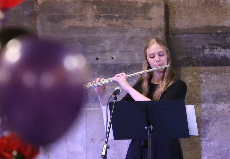 Aubrey Sanders a senior at Ottawa Township High School performs on her flute during the 7th annual Mad Hatter Ball on Friday, Nov. 17, 2023 at the Westclox Event Center in Peru.