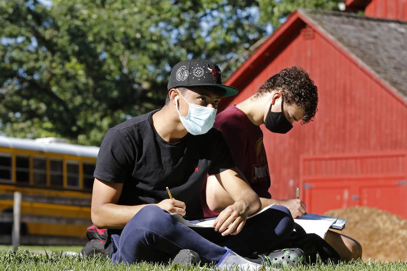 McHenry High School art students Kaiden DeLeon, front, and Rian Austin sketch the historic Colby/Petersen farm property on Wednesday, Sept. 8, 2021 in McHenry. The site has been on the City of McHenry's historic registry since 1998 and earned a place on the national registry last year. The art students took turns touring the property and creating sketches of it, with the possibility that one of the pieces of art will be enshrined on the new national registry plaque.