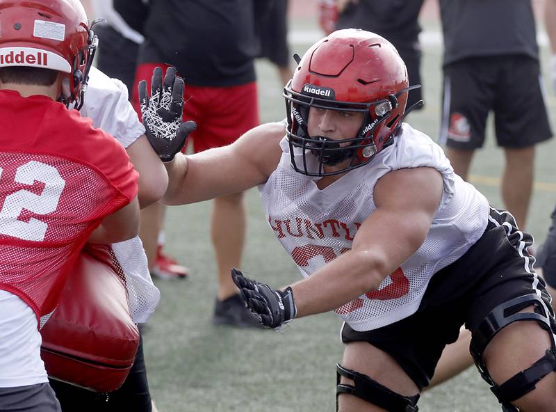 Huntley's Jack Crudele blocks during the first day of football practice Monday, August 7, 2023, at the Huntley High School’s Red Raider Stadium.