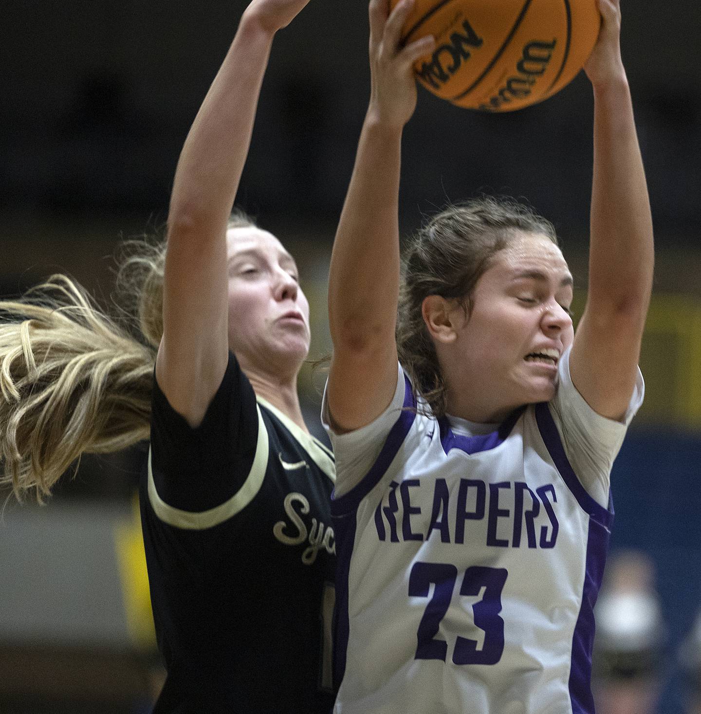 Sycamore’s Sadie Lang and Plano’s Josie Larson work for a rebound Monday, Feb. 17, 2025, during a 3A semifinal in Sterling.