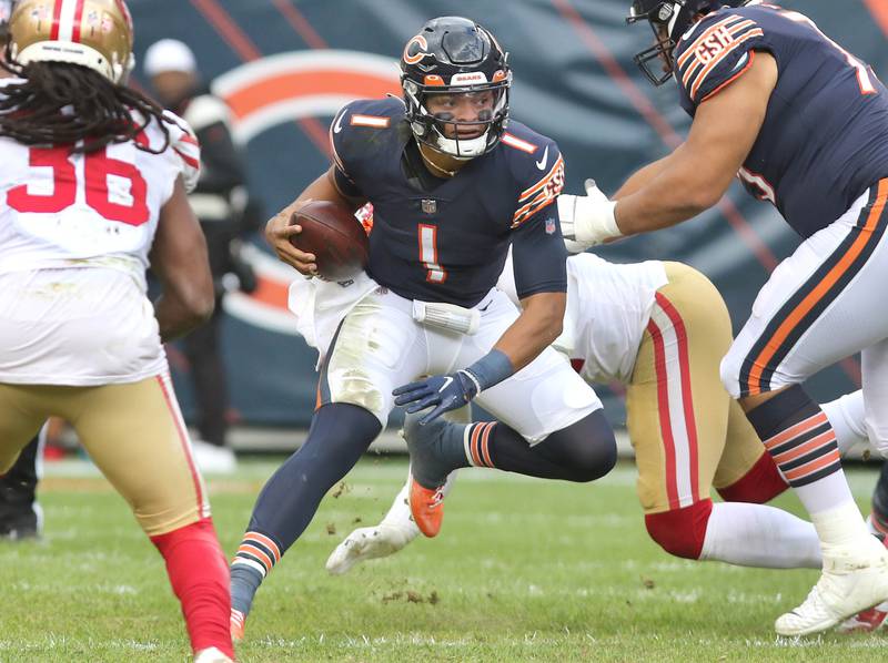 Chicago Bears quarterback Justin Fields scrambles away from San Francisco 49ers pass rush for positive yards during their game Sunday, Oct. 31, 2021, at Soldier Field in Chicago.