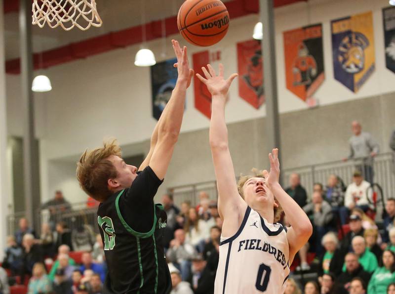Fieldcrest's Jordan Heider takes a shot in the lane as Rock Falls's Aydan Goff defends during the 49th annual Colmone Classic on Saturday, Dec. 9, 2023 at Hall High School.