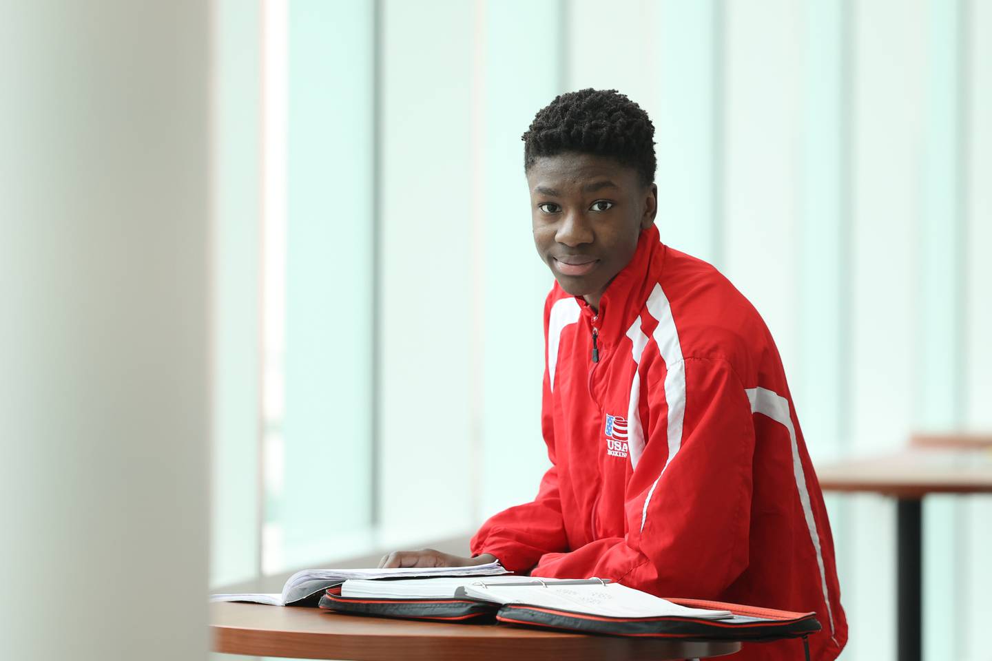 Joseph Awinongya, 15 years-old, poses for a photo after class at Joliet Junior College on Tuesday, February 14th.